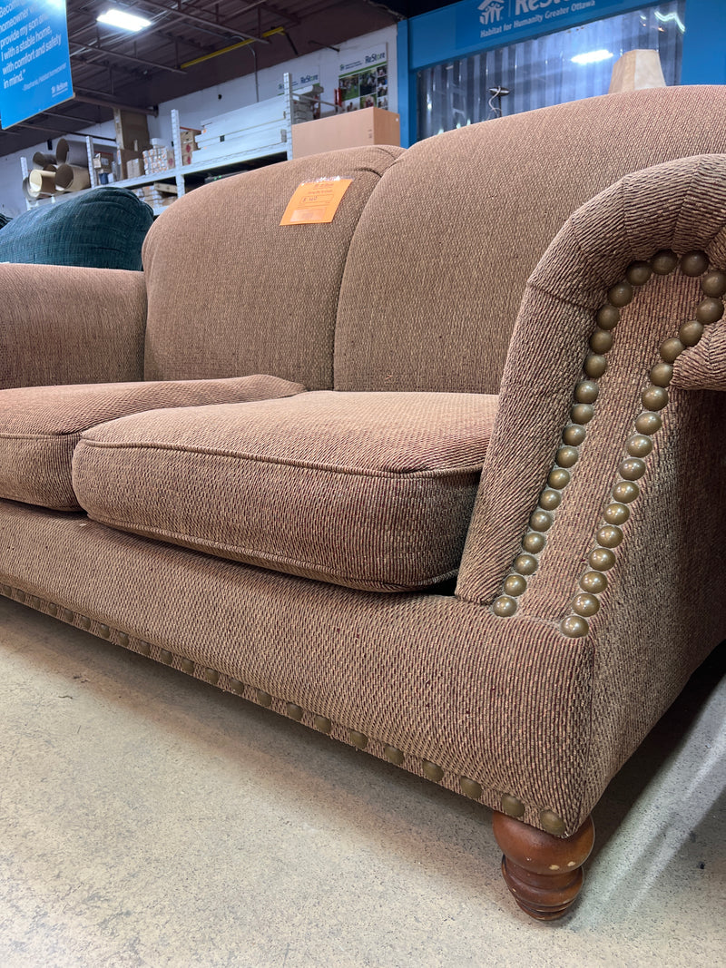 Tan Textured Fabric Loveseat with Rolled Arms and Nailhead Trim