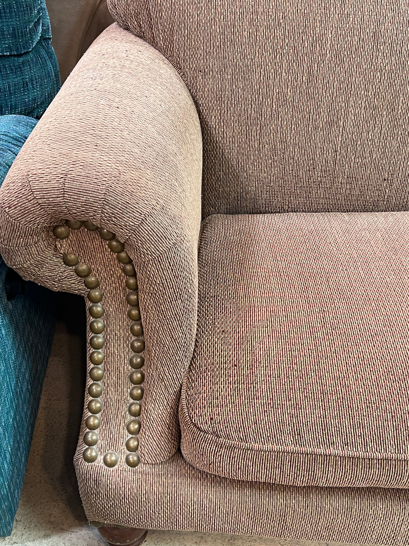 Tan Textured Fabric Loveseat with Rolled Arms and Nailhead Trim