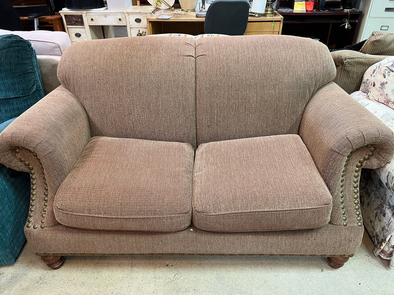 Tan Textured Fabric Loveseat with Rolled Arms and Nailhead Trim