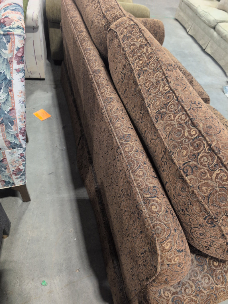 Brown 2 Seater Sofa with Swirly Patterns and Pillows