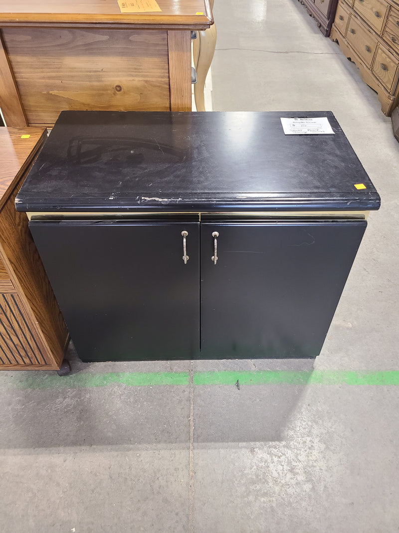 Small Black Two-Door Storage Cabinet with Metallic Trim