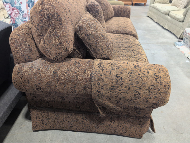 Brown 2 Seater Sofa with Swirly Patterns and Pillows