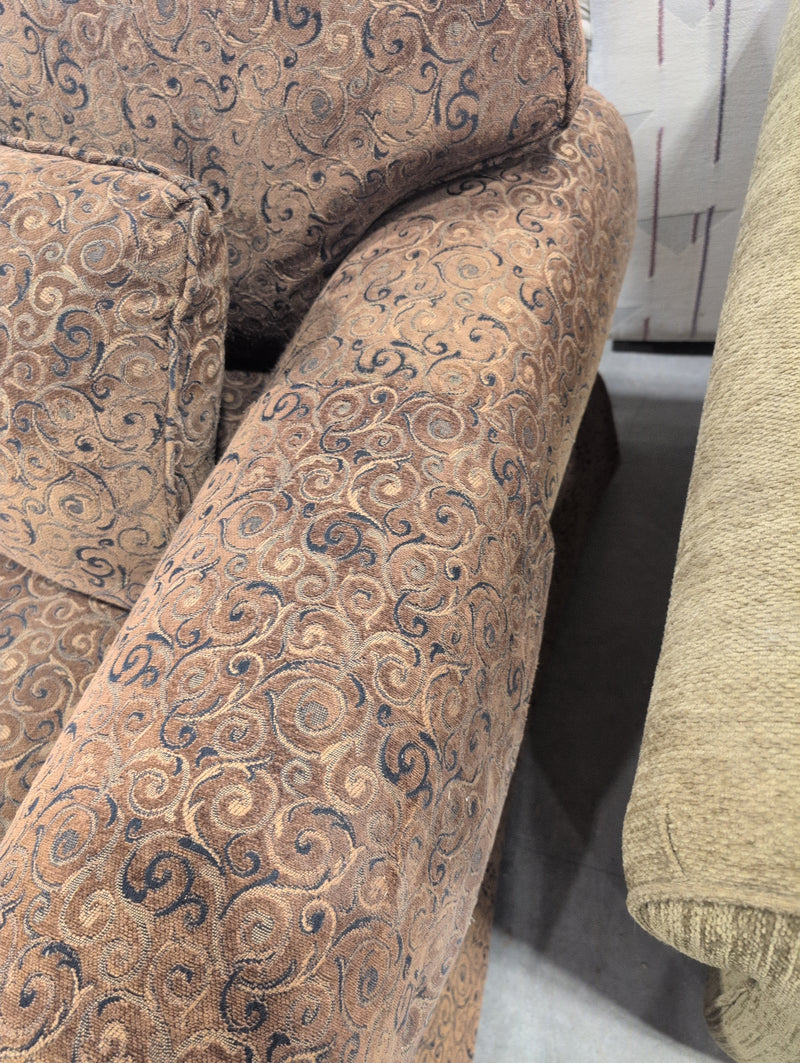 Brown 2 Seater Sofa with Swirly Patterns and Pillows