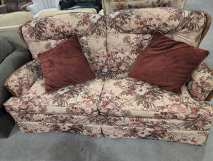 Red and Yellow Sofa with Floral Designs and Pillows