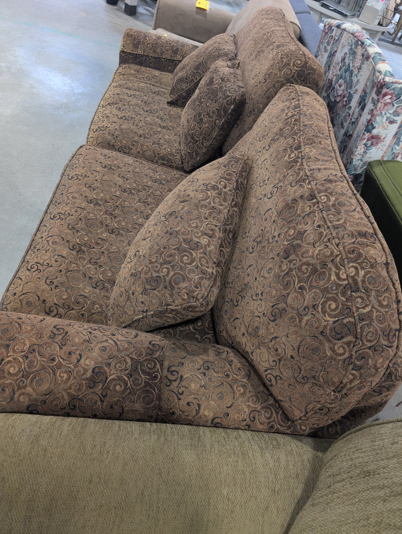 Brown 2 Seater Sofa with Swirly Patterns and Pillows