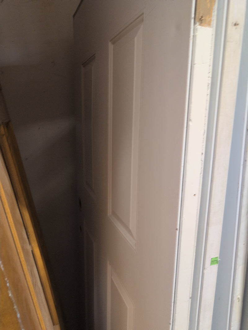White Exterior Door with Pre-Drilled Holes and a Door Knocker