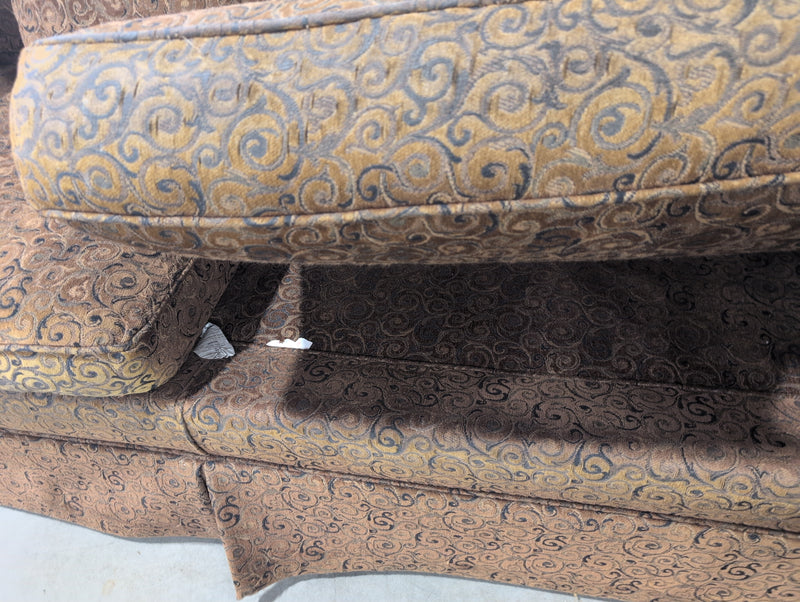 Brown 2 Seater Sofa with Swirly Patterns and Pillows