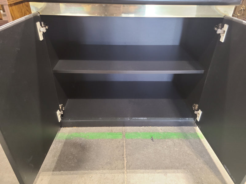 Small Black Two-Door Storage Cabinet with Metallic Trim