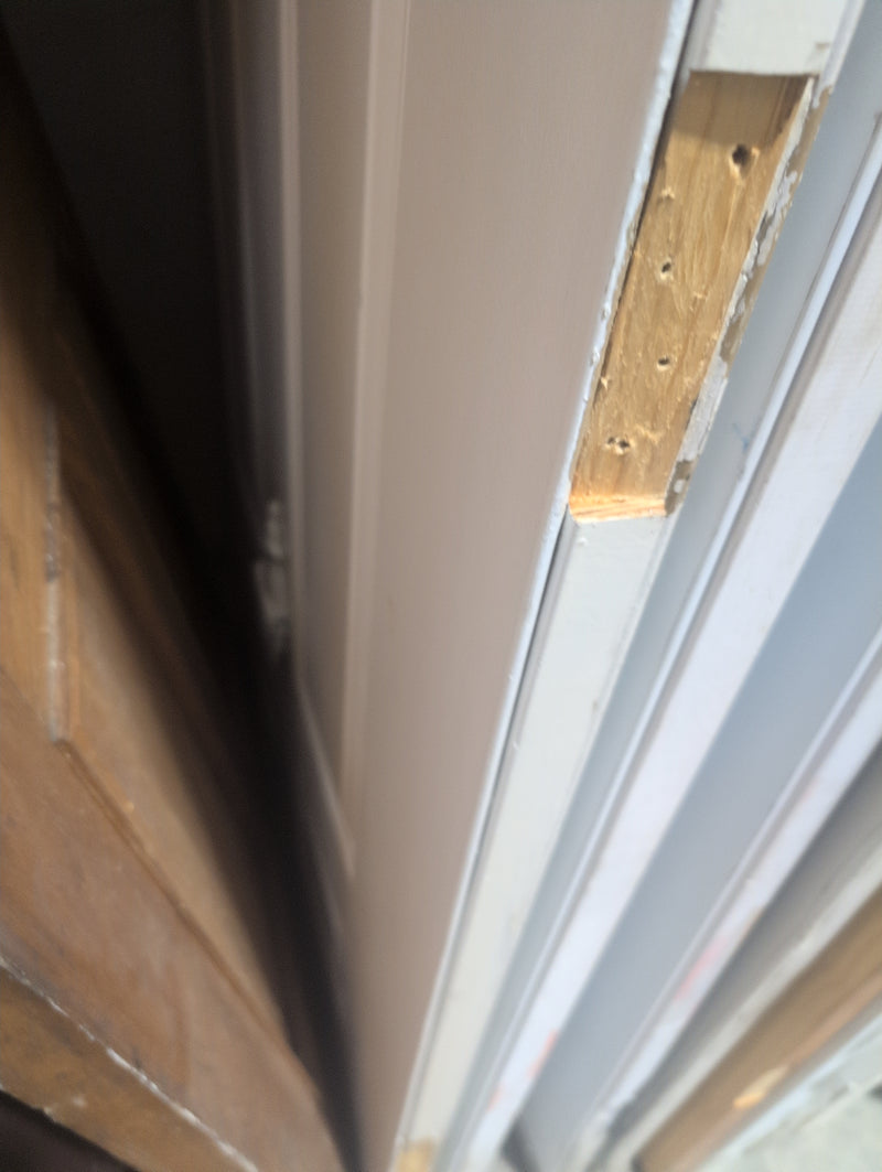 White Exterior Door with Pre-Drilled Holes and a Door Knocker