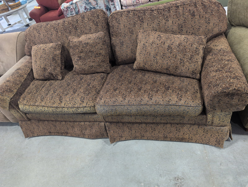 Brown 2 Seater Sofa with Swirly Patterns and Pillows