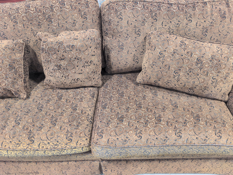 Brown 2 Seater Sofa with Swirly Patterns and Pillows